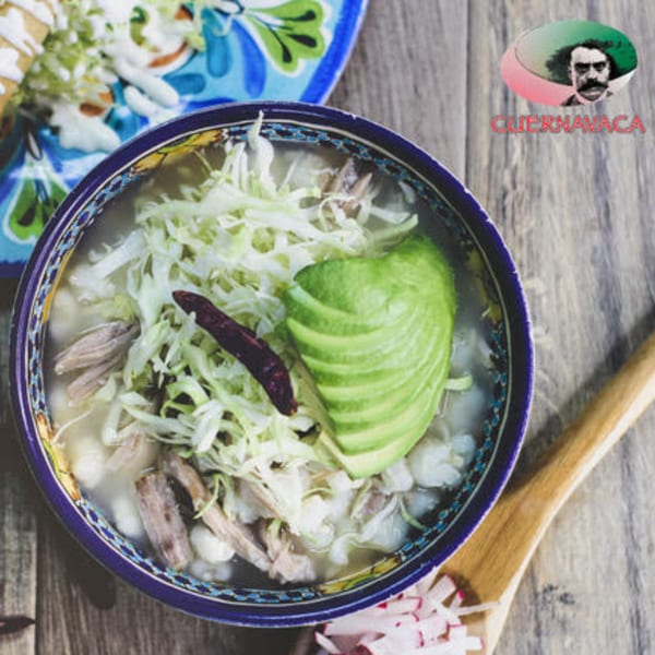 Pozole from Taqueria Cuernavaca, with shredded pork, hominy, cabbage, avocado, and a chili.