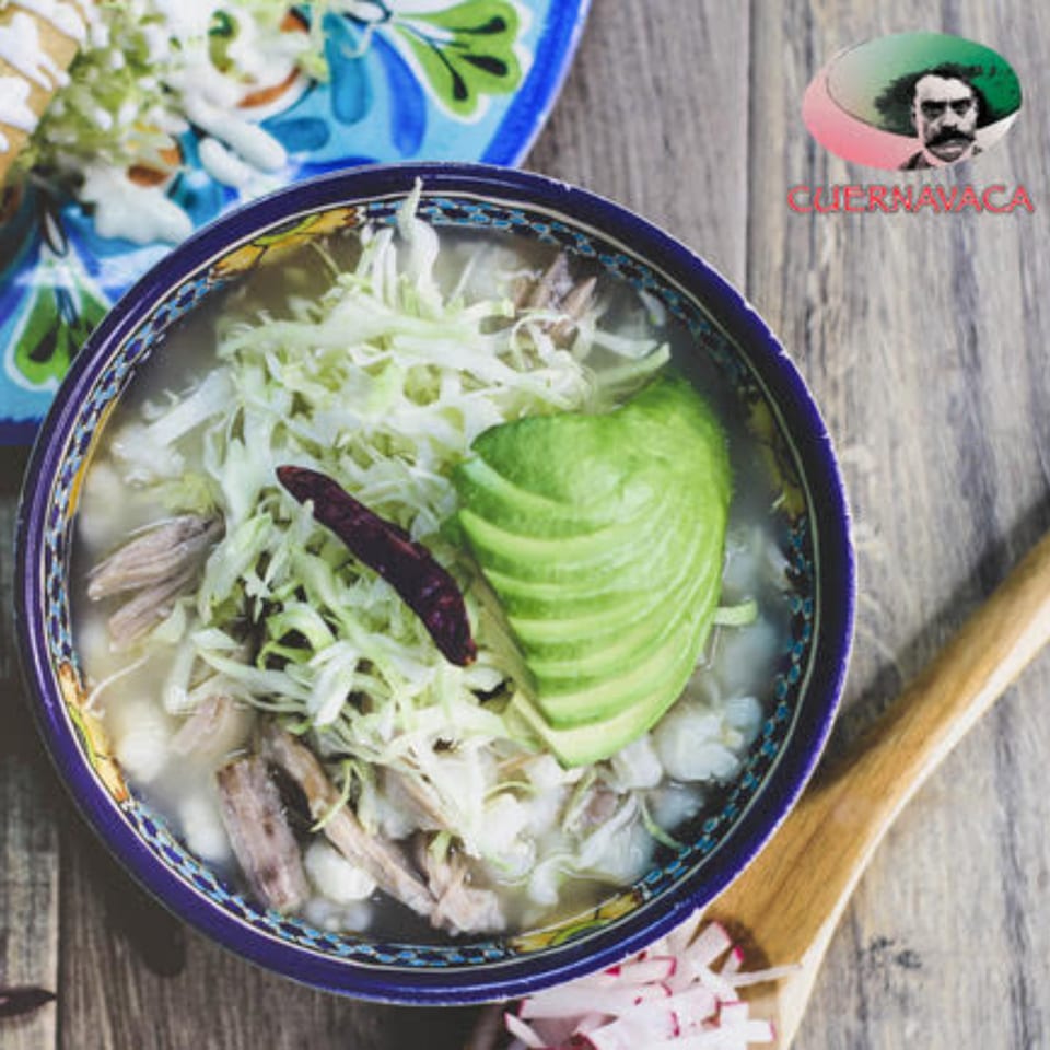 Pozole from Taqueria Cuernavaca, with shredded pork, hominy, cabbage, avocado, and a chili.